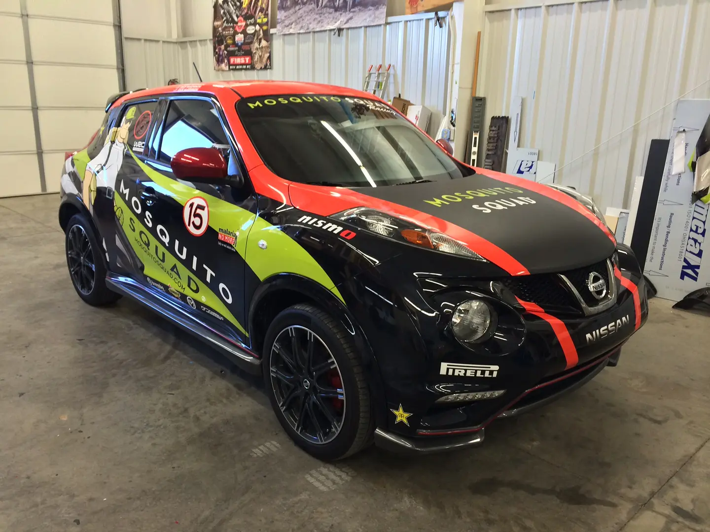 Black compact car with red and yellow-green racing graphics