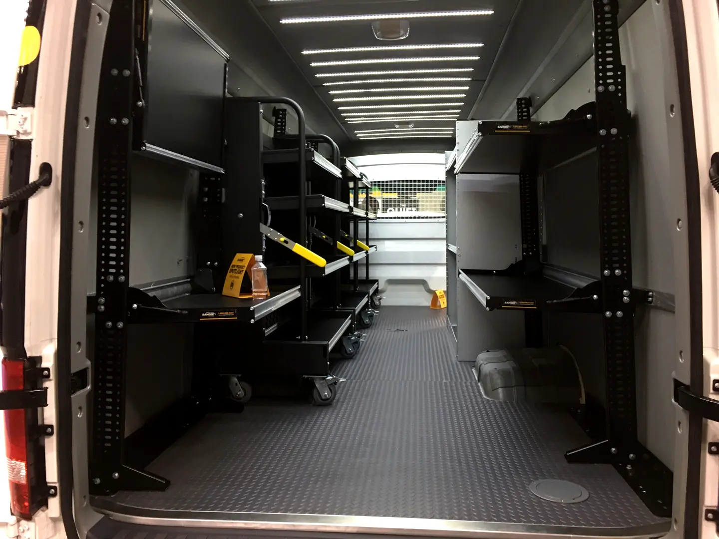 Work van interior with black storage units on both sides