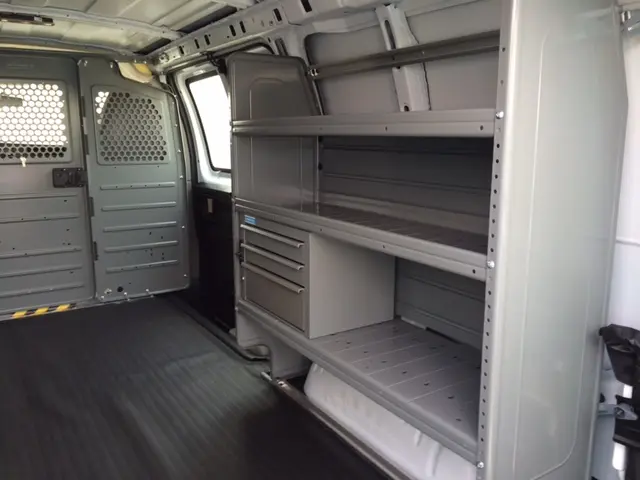 Work van interior with gray shelving and drawer storage