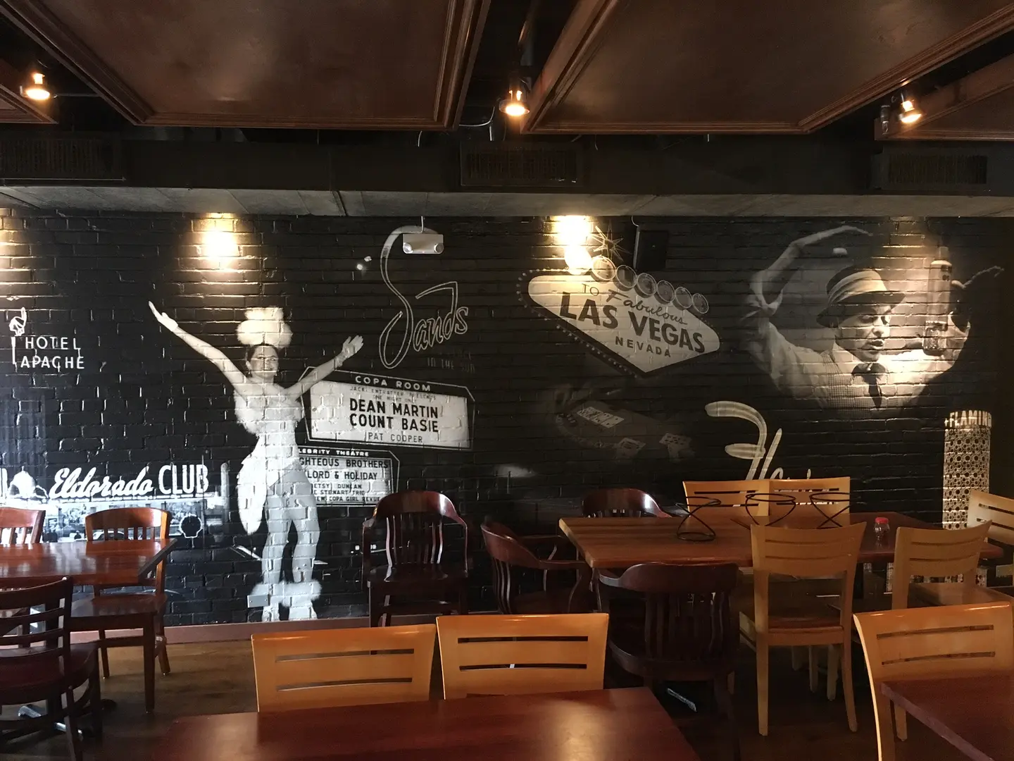 Black-and-white wall mural behind restaurant tables
