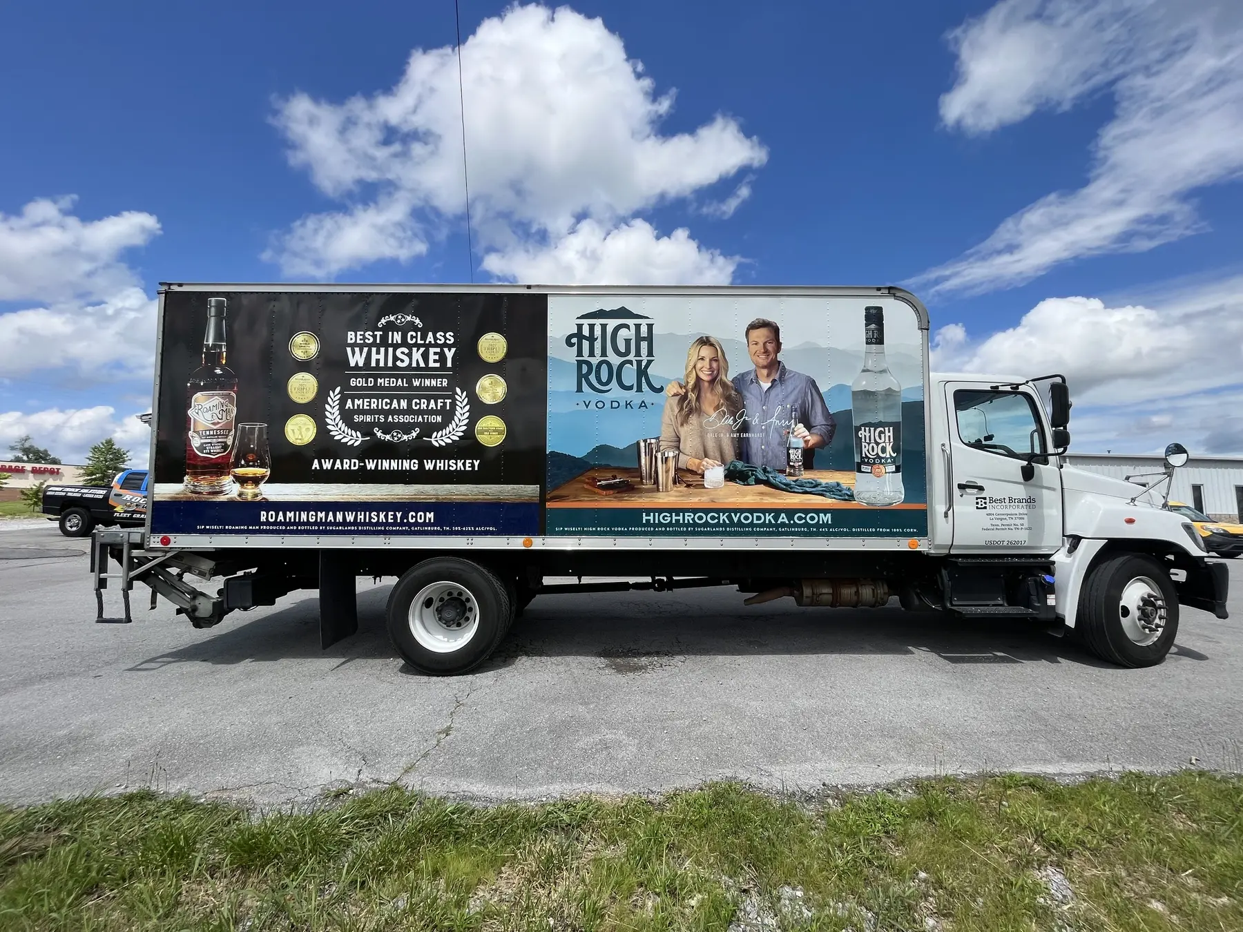 White box truck with large beverage graphics along its side